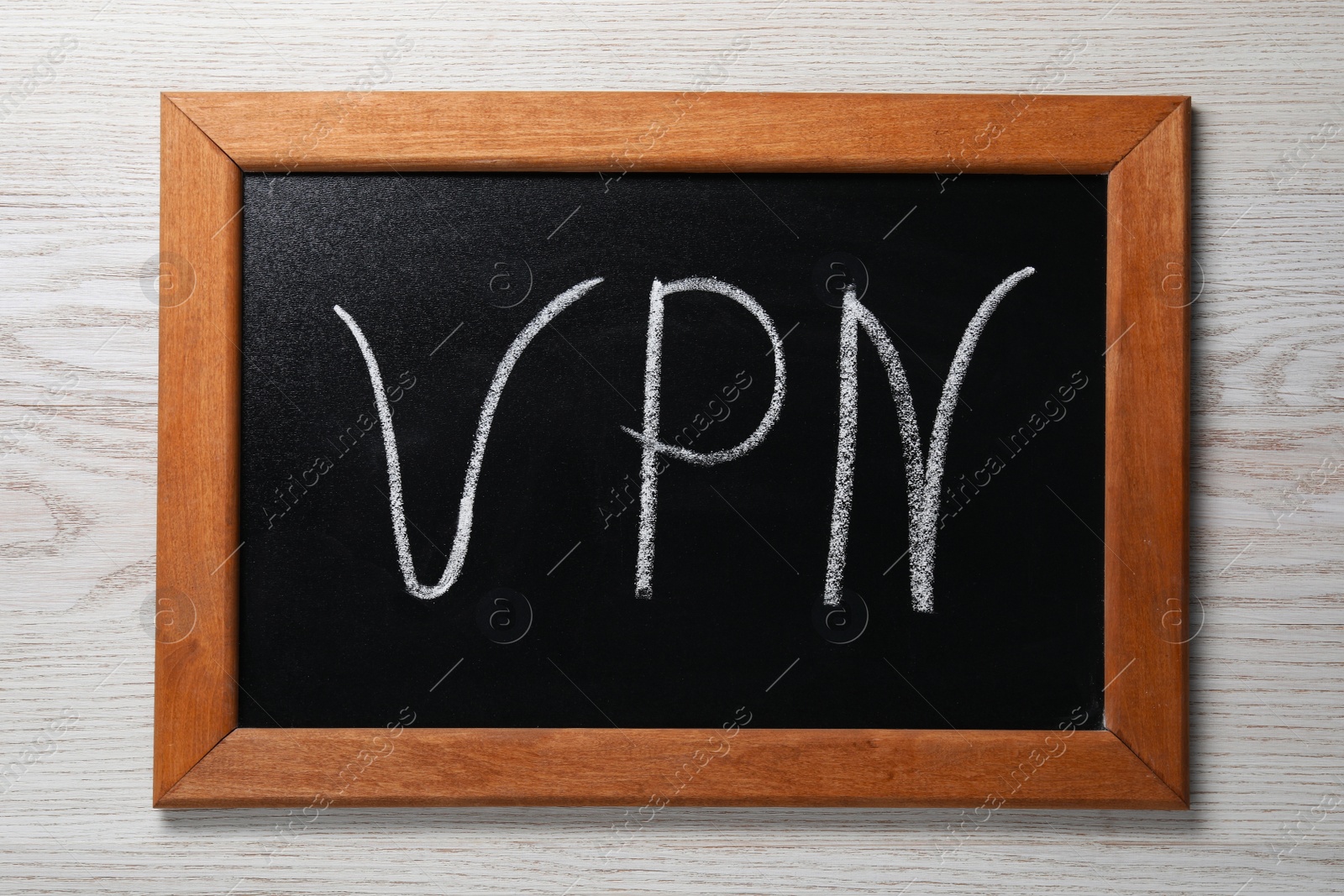 Photo of Chalkboard with acronym VPN on wooden table, top view