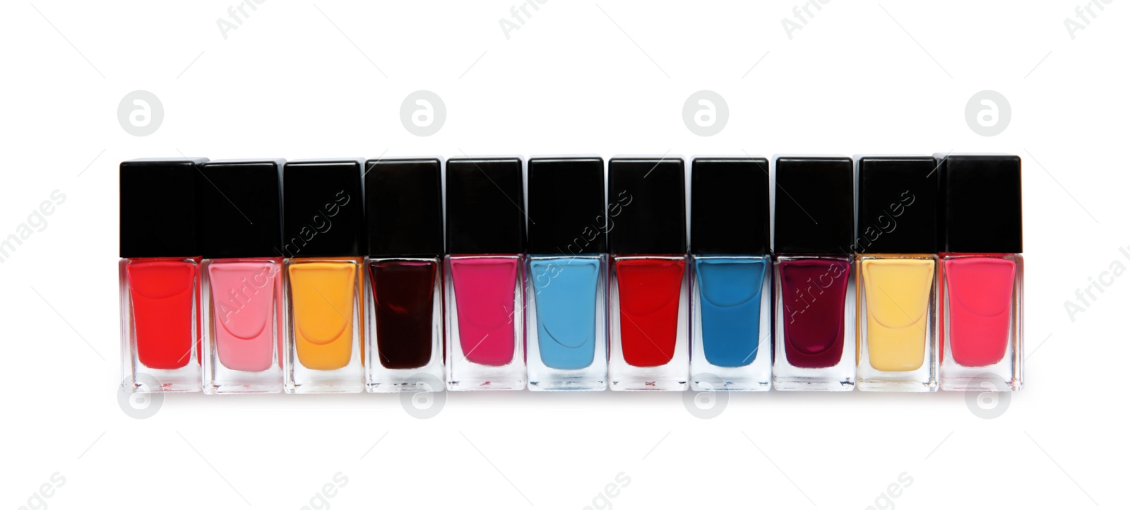 Photo of Bottles of nail polish on white background, top view