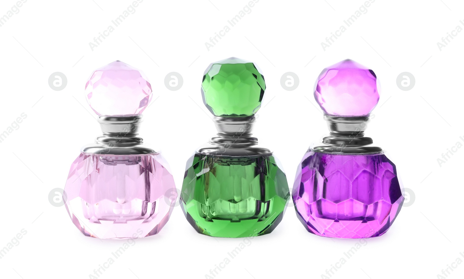 Photo of Bottles of luxury perfume isolated on white