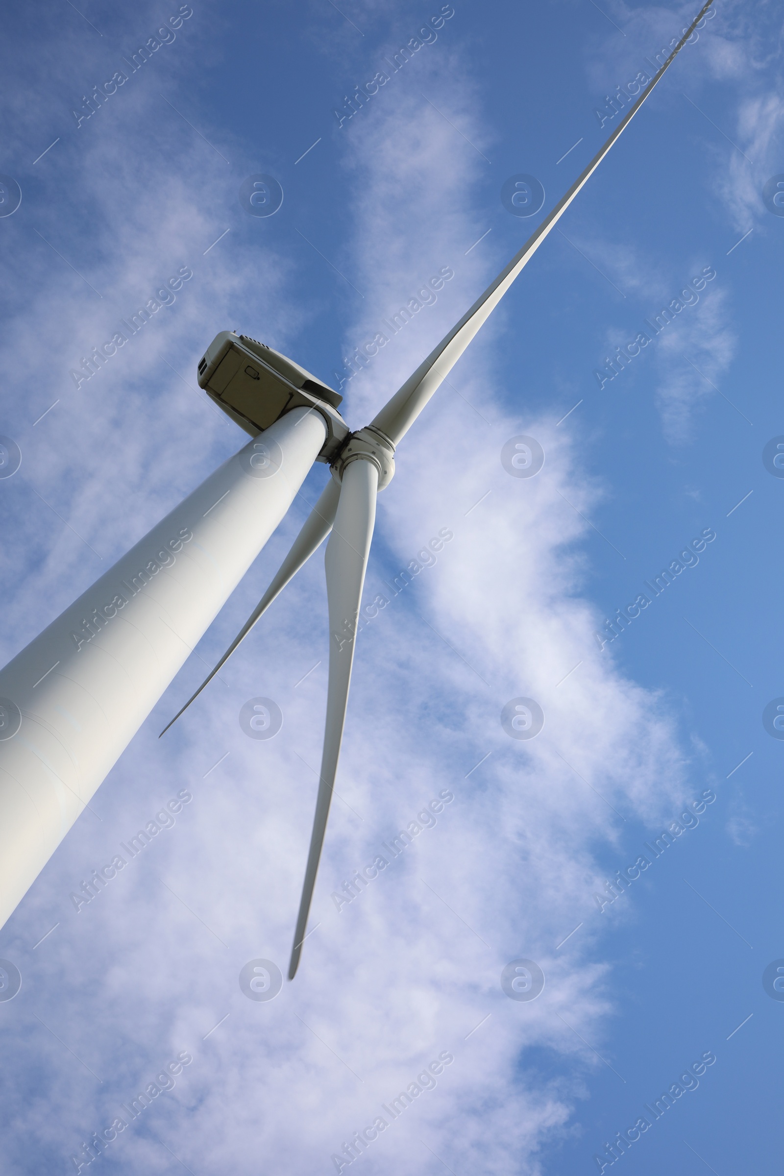 Photo of Wind turbine against beautiful blue sky, low angle view. Alternative energy source