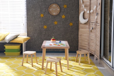 Baby room interior with wooden furniture and toys