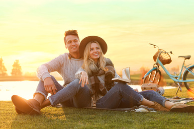 Happy young couple spending time together on picnic outdoors