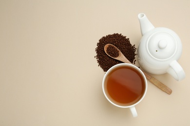 Buckwheat tea and granules on beige background, flat lay. Space for text