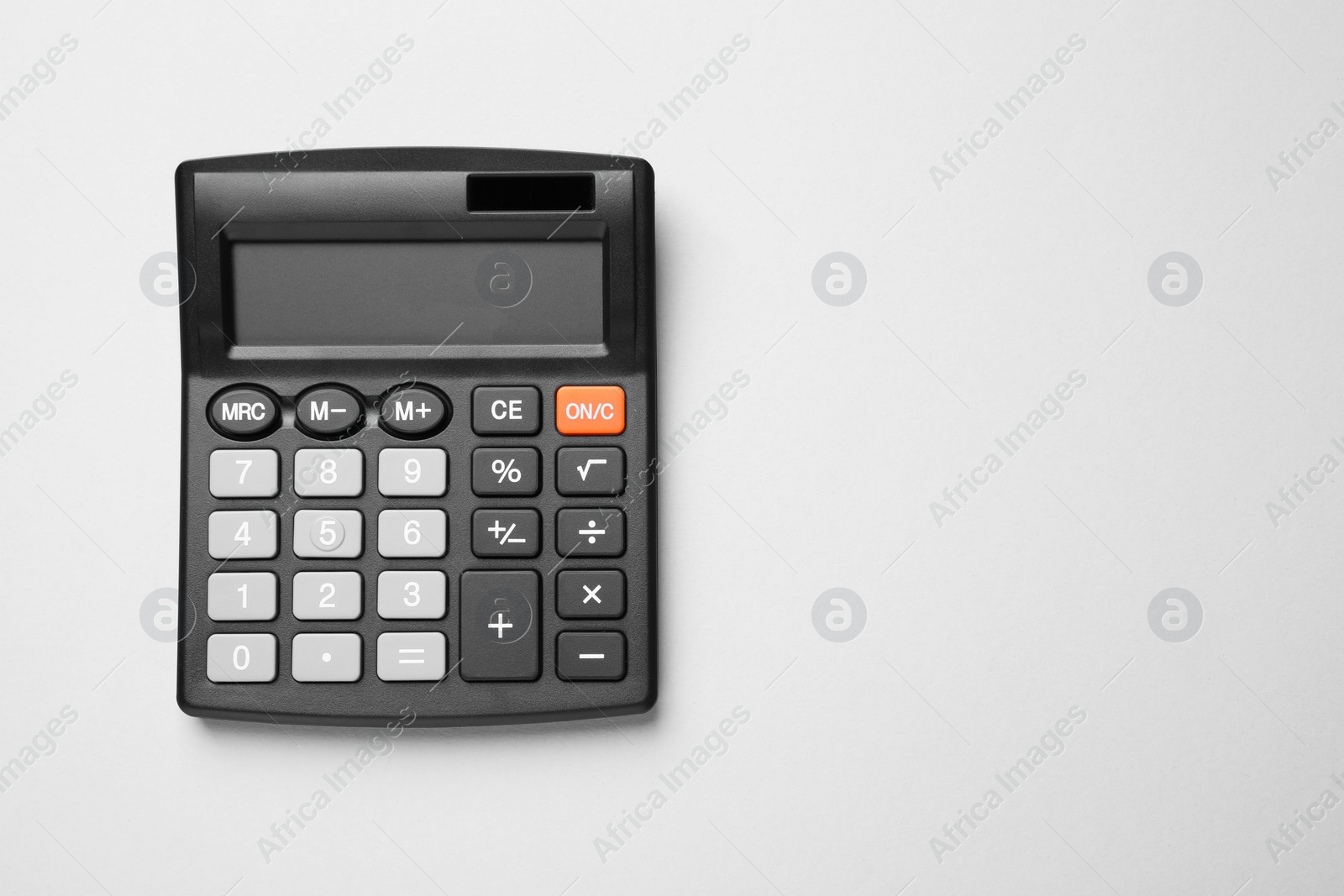 Photo of Calculator on light gray background, top view. Space for text