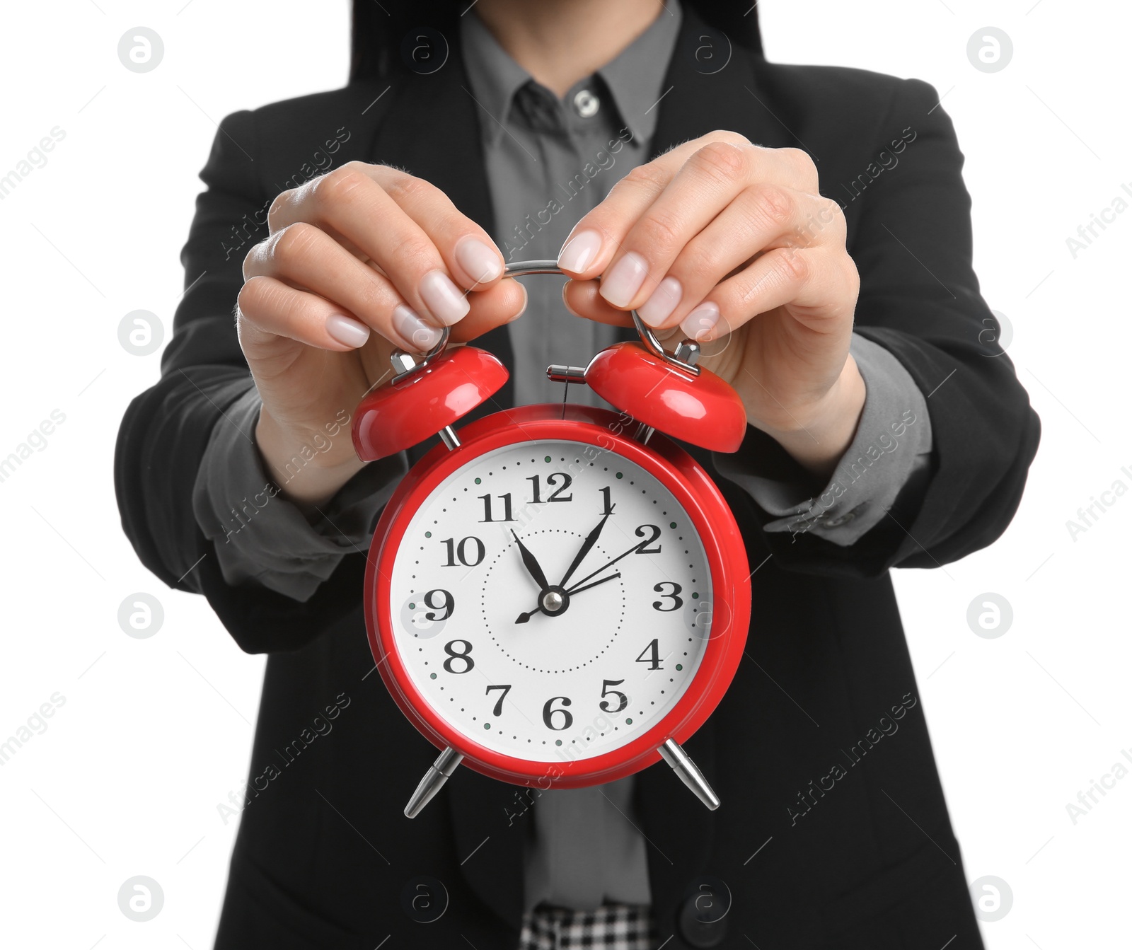 Photo of Businesswoman holding alarm clock on white background, closeup. Time management