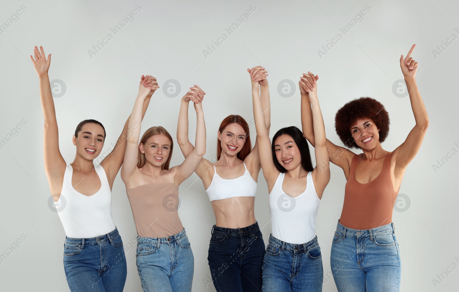 Photo of Group of beautiful young women on light grey background