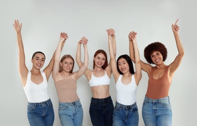 Photo of Group of beautiful young women on light grey background