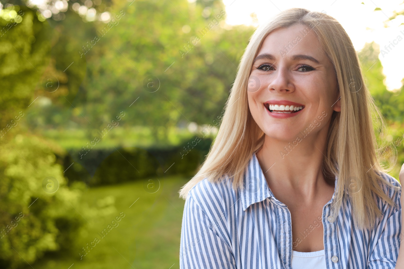 Photo of Portrait of beautiful woman outdoors on sunny day, space for text