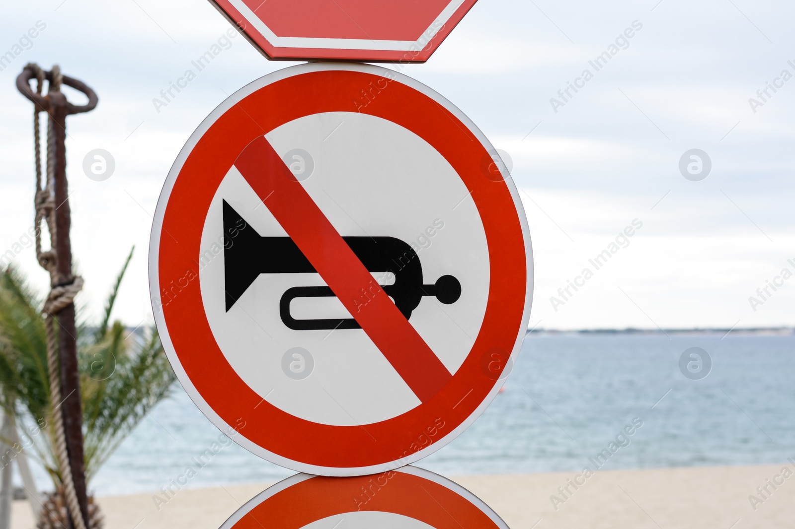 Photo of Post with No Horn traffic sign near sea outdoors
