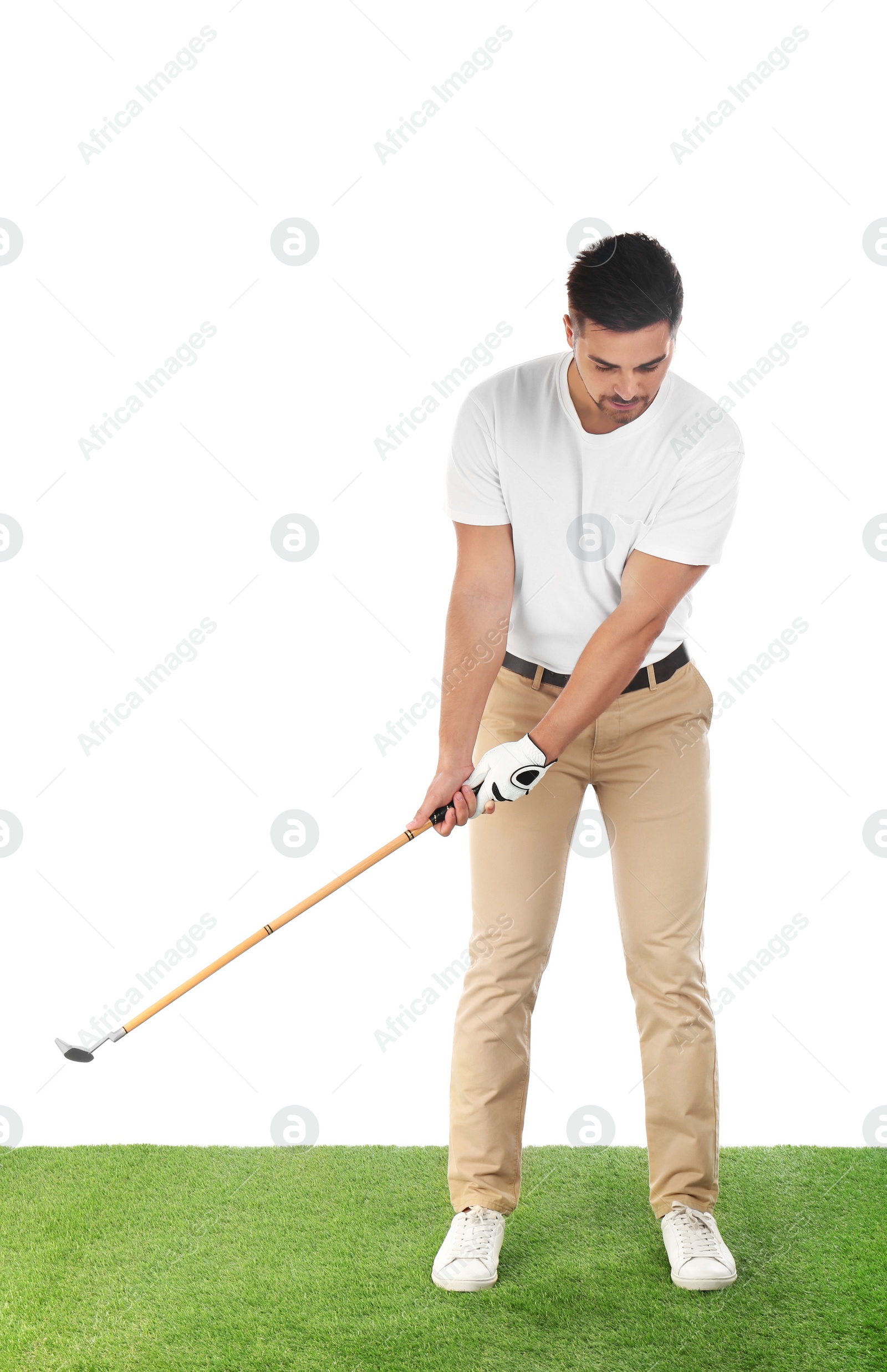 Photo of Young man playing golf on course against white background