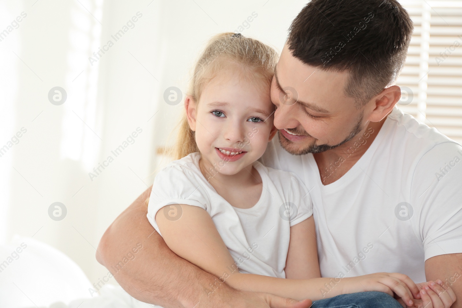 Photo of Dad and daughter spending time together at home. Happy Father's Day