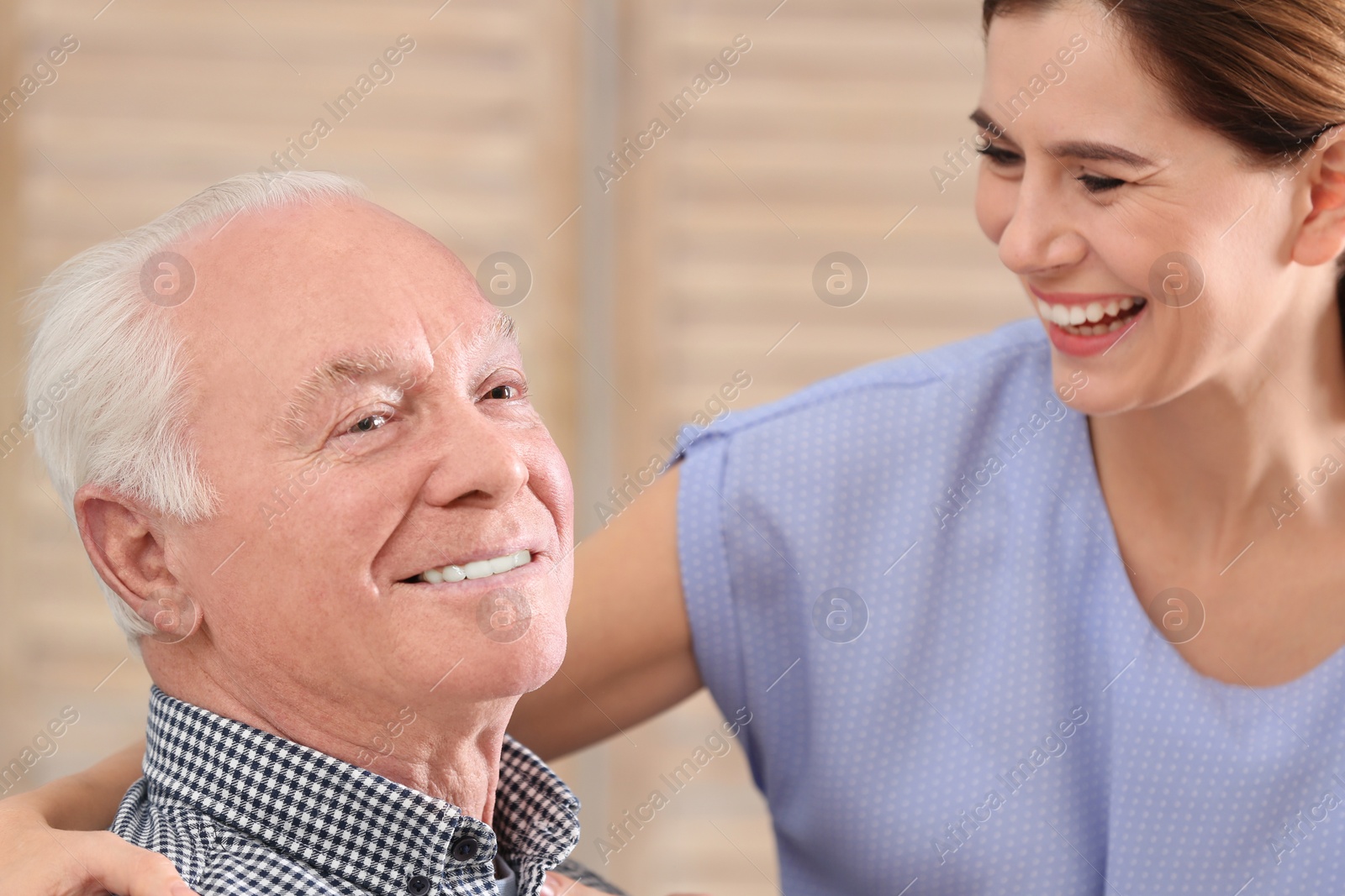 Photo of Elderly man with female caregiver at home