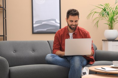 Man using laptop for online shopping at home