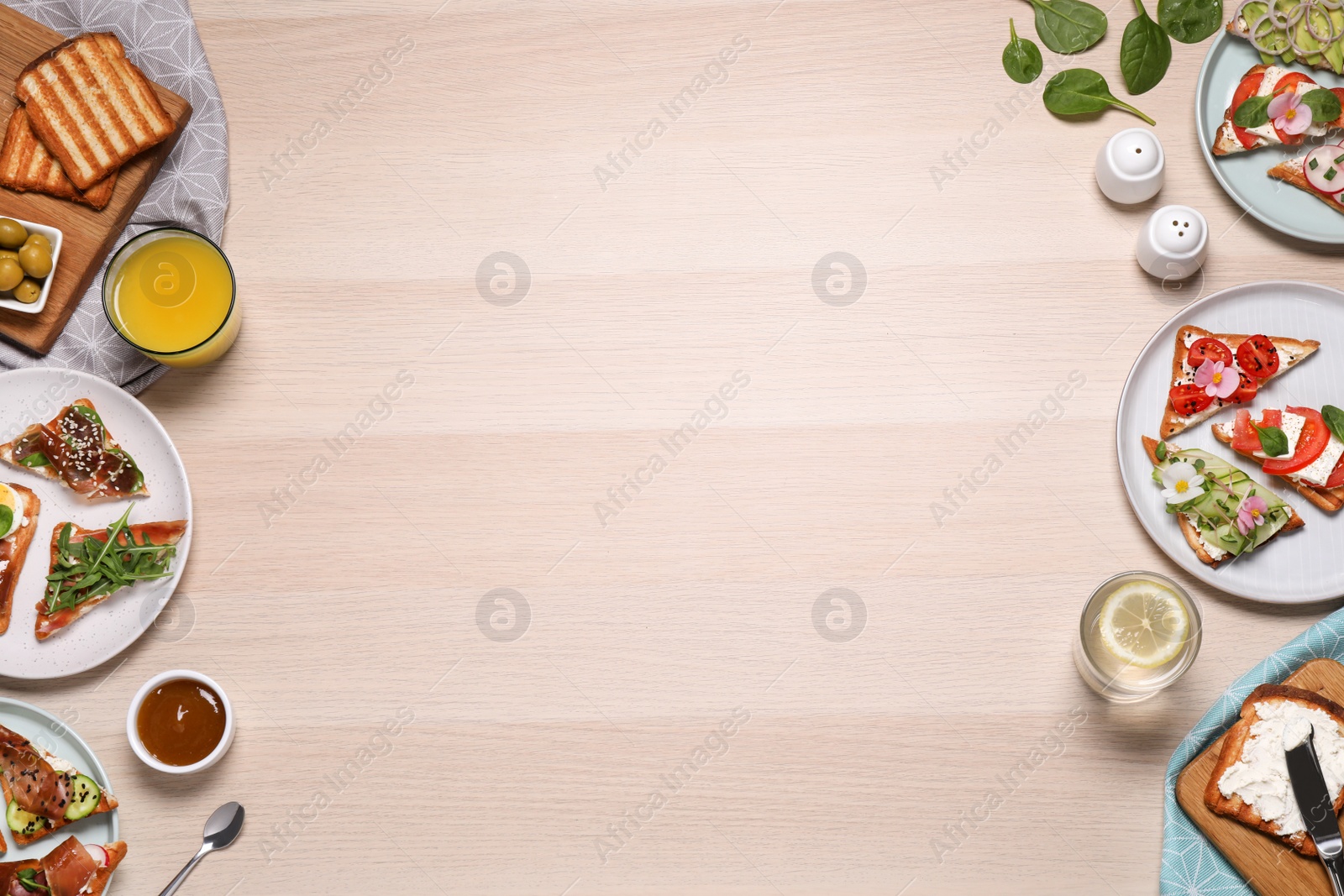 Photo of Tasty breakfast with different sandwiches served on wooden table, flat lay. Space for text