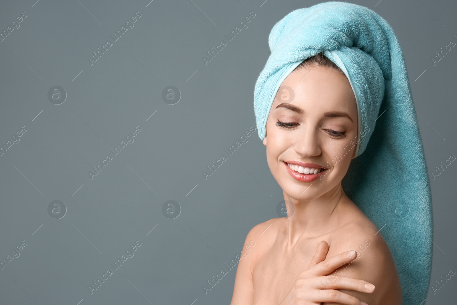 Photo of Beautiful young woman with silky skin on grey background