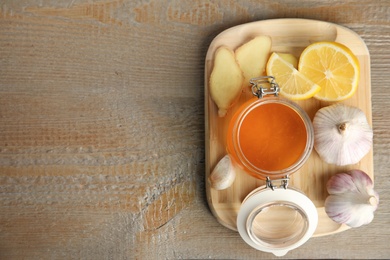 Photo of Cold remedies on wooden table, top view with space for text. Sore throat treatment