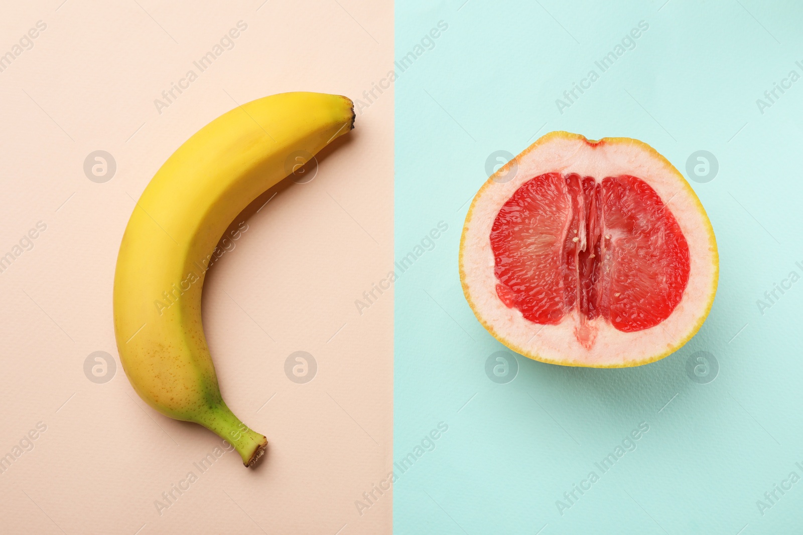 Photo of Banana and half of grapefruit on color background, flat lay. Sex concept