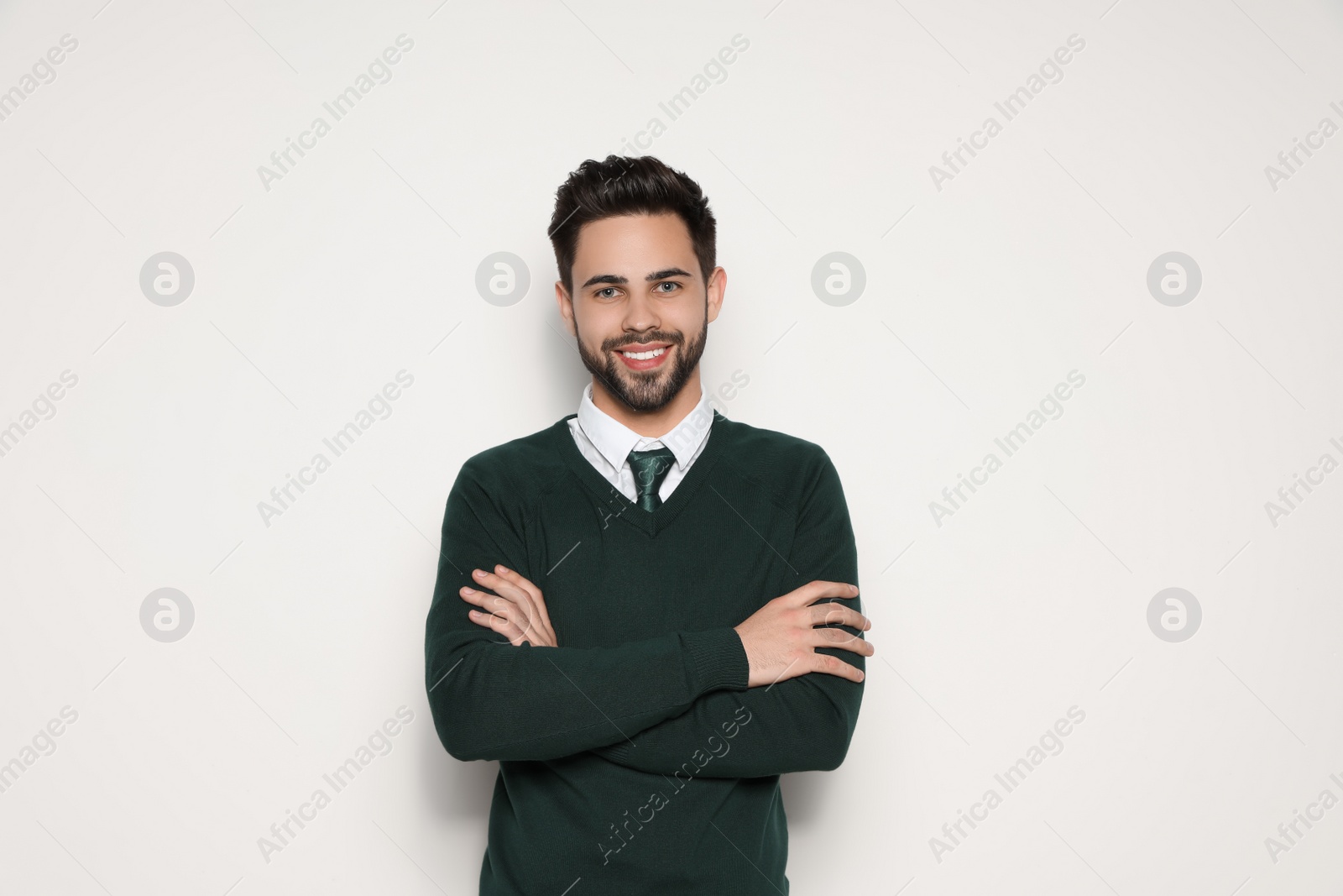 Photo of Portrait of handsome young man smiling on light background