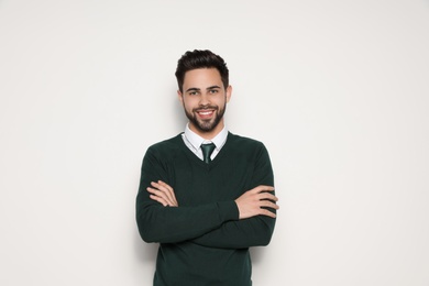 Photo of Portrait of handsome young man smiling on light background