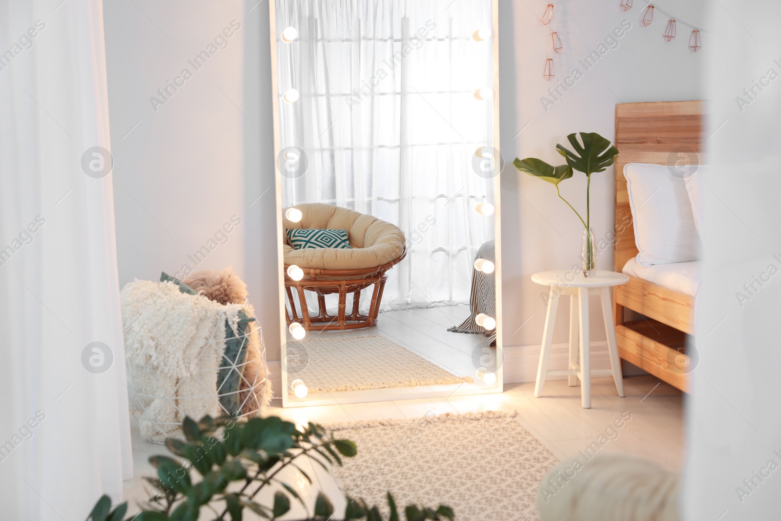 Photo of Large mirror with light bulbs in stylish room interior