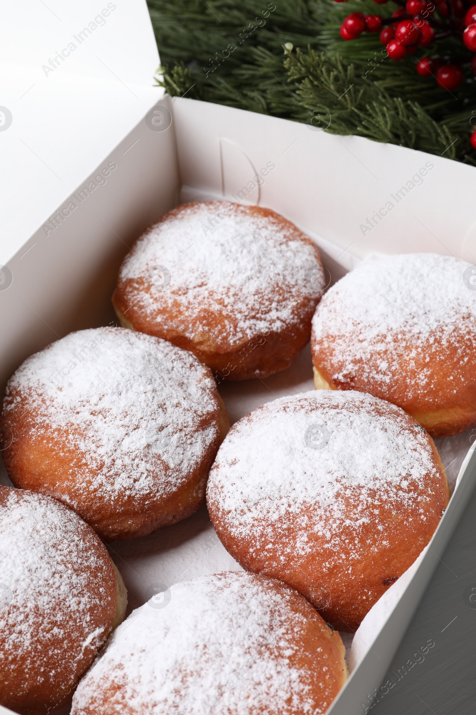 Photo of Delicious sweet buns in box on table, closeup