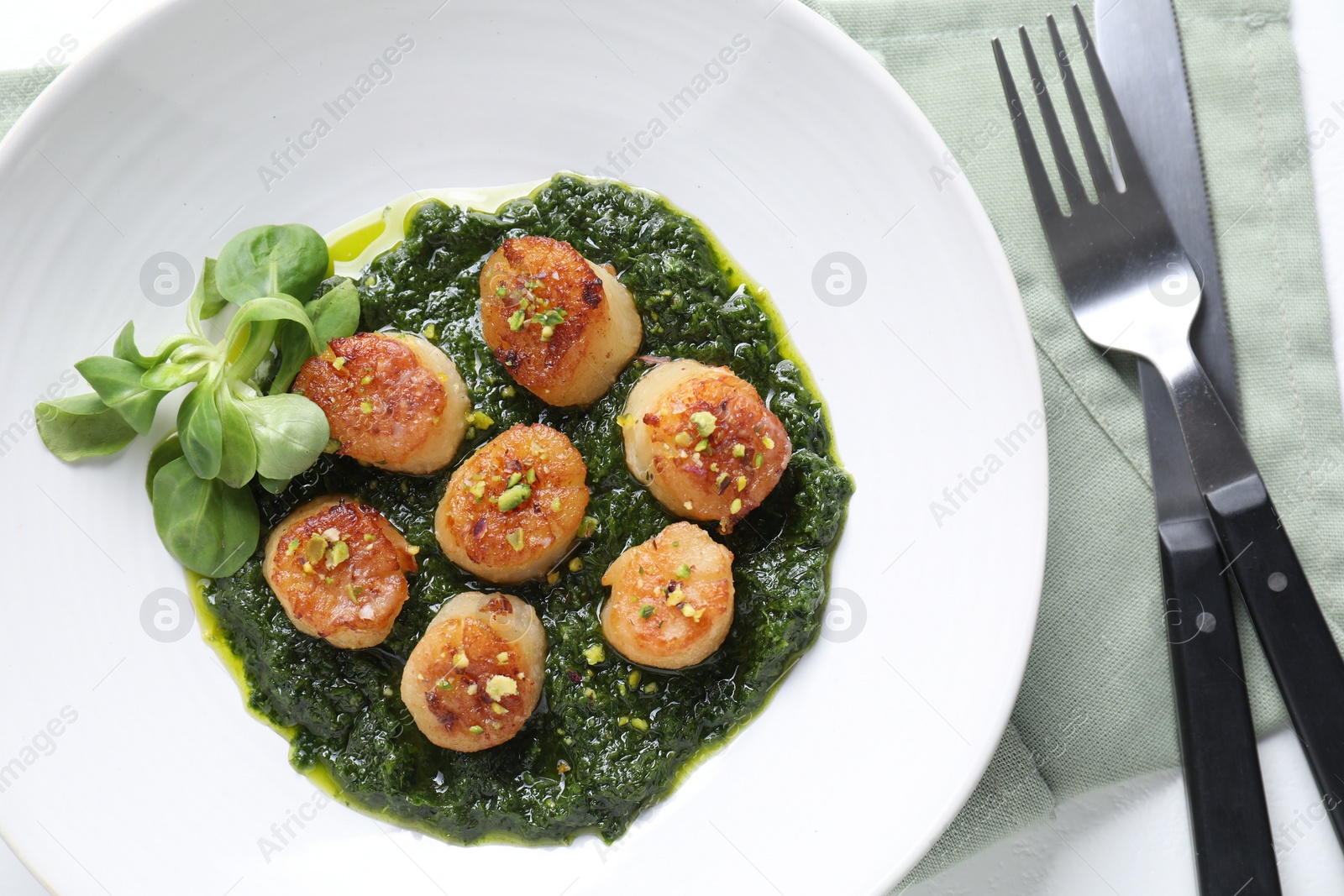 Photo of Delicious fried scallops in bowl served on table, flat lay