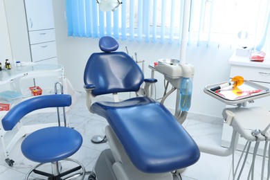 Photo of Dentist's office interior with chair and modern equipment
