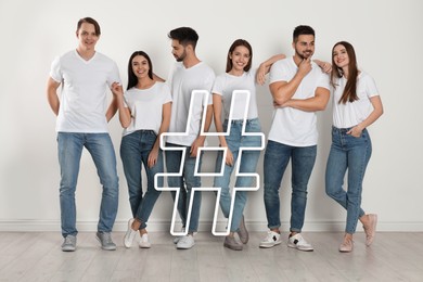 Image of Hashtag icon and group of happy people indoors