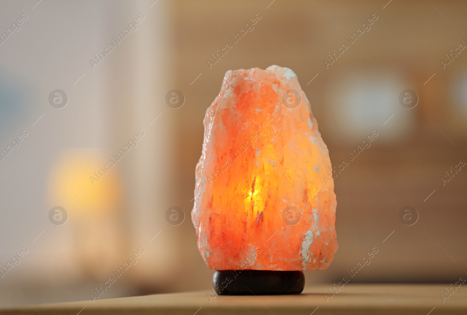 Photo of Himalayan salt lamp on table at home