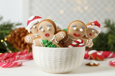 Photo of Delicious homemade Christmas cookies in bowl on white wooden table