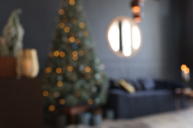 Blurred view of living room interior with Christmas tree and festive decor