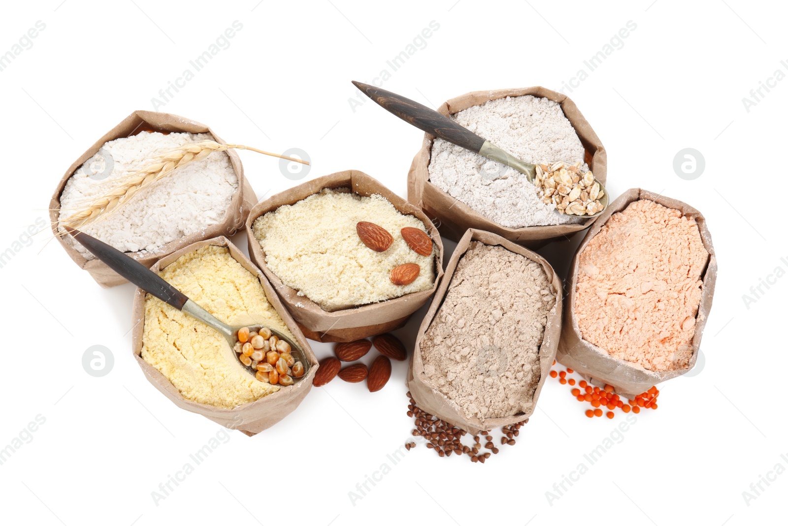 Photo of Paper bags with different types of flour on white background, above view