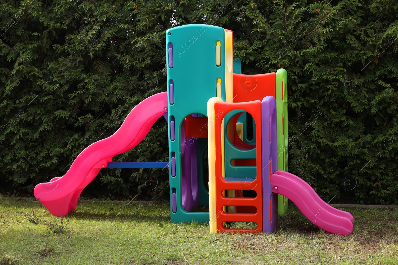 Photo of Children's colorful playground with slides and tunnel
outdoors