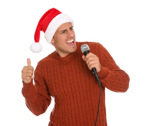 Photo of Emotional man in Santa Claus hat singing with microphone on white background. Christmas music