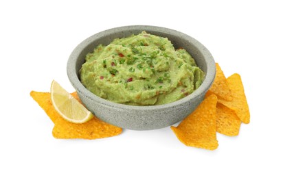Bowl of delicious guacamole, lime and nachos chips isolated on white