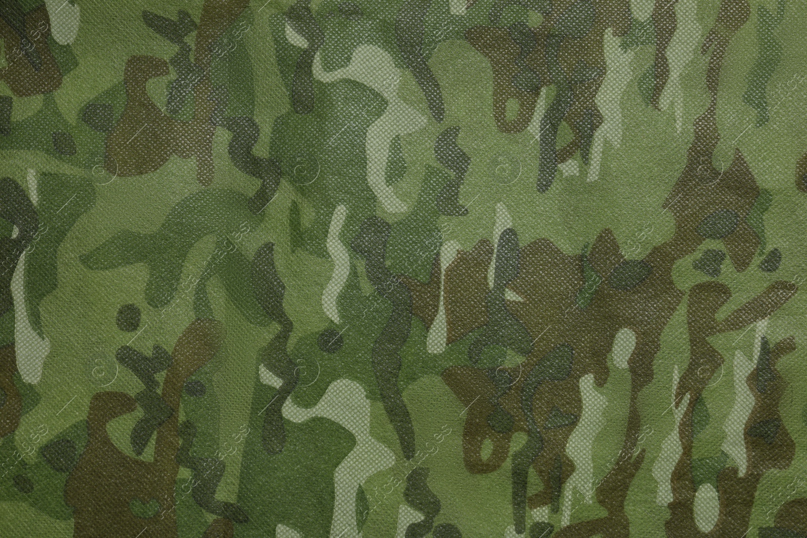 Photo of Texture of camouflage fabric as background, top view