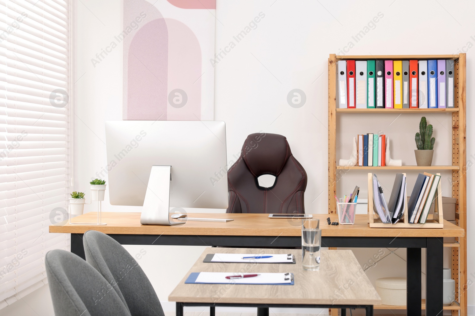 Photo of Director's office with large wooden table and comfortable armchairs. Interior design