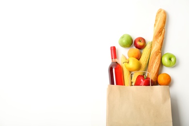 Flat lay composition with shopping bag and products on white background