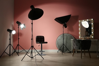 Different professional lighting equipment in modern photo studio