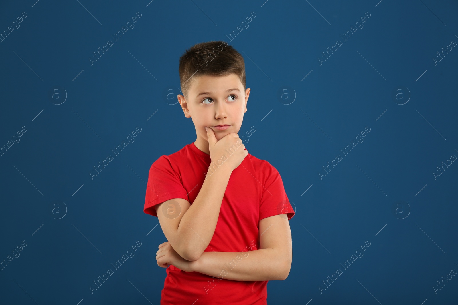 Photo of Portrait of emotional preteen boy on blue background