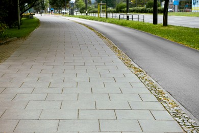 Sidewalk path near bike lane outdoors. Footpath covering