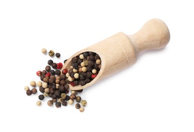 Photo of Aromatic spices. Different peppers and wooden scoop isolated on white, top view