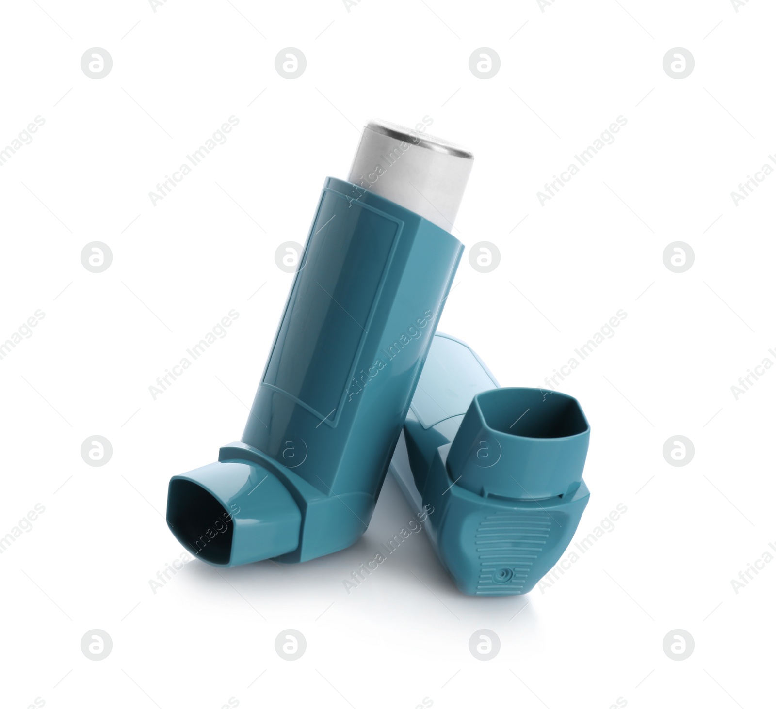 Photo of Two portable asthma inhalers on white background