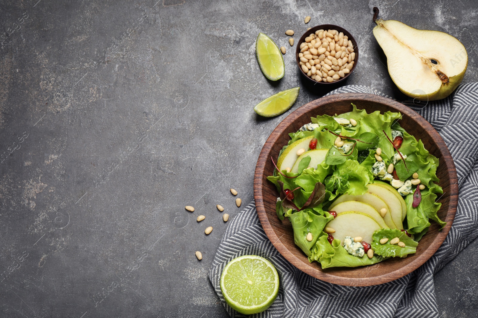 Photo of Fresh salad with pear and ingredients on grey table, flat lay. Space for text