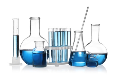 Photo of Set of laboratory glassware with blue liquid isolated on white