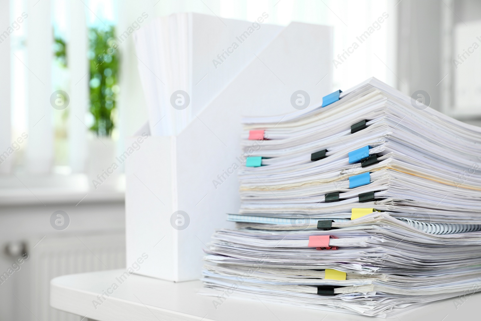 Photo of Table with lots of documents in office