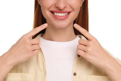 Woman showing her clean teeth and smiling on white background, closeup