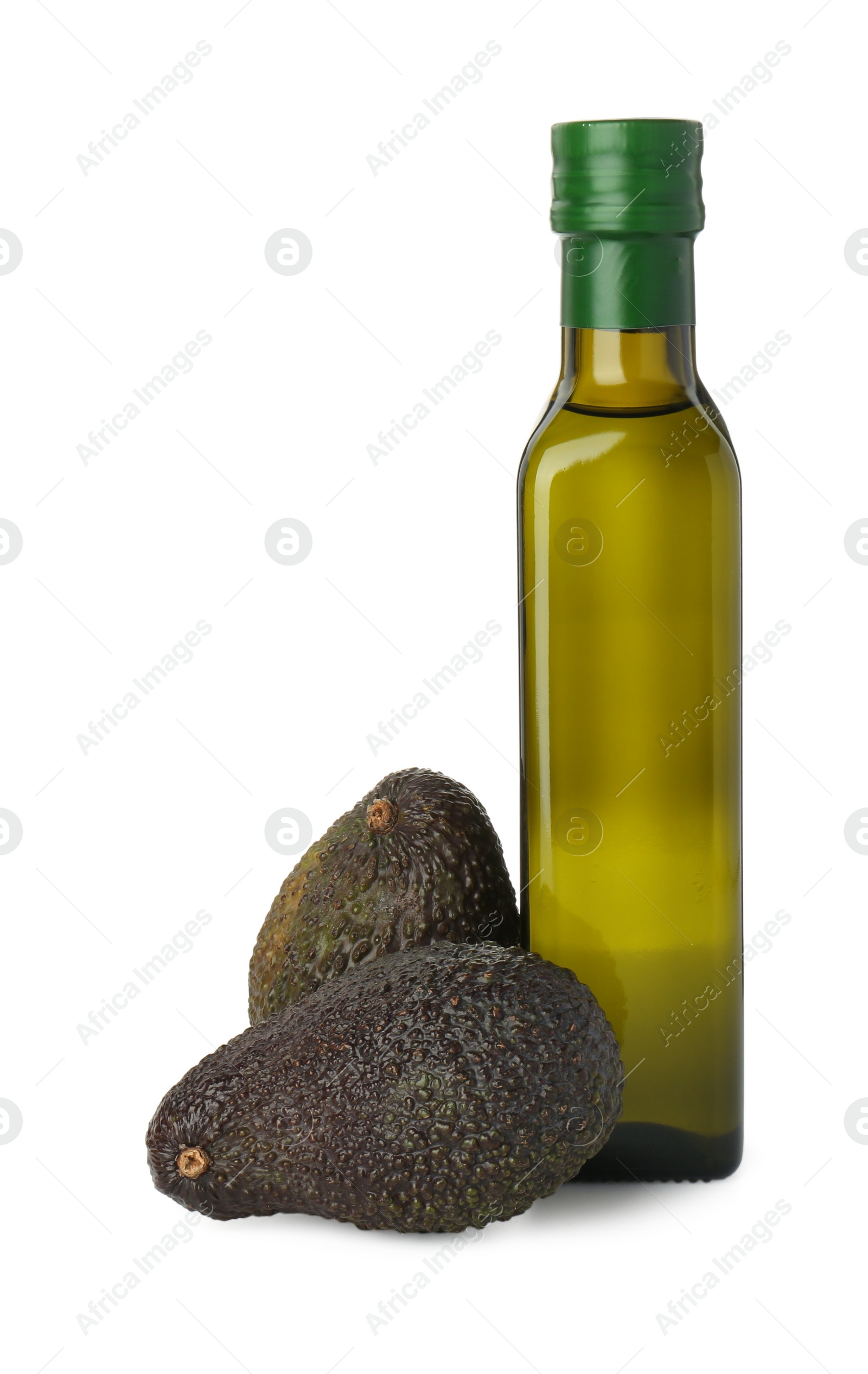 Photo of Vegetable fats. Bottle of cooking oil and fresh avocados isolated on white