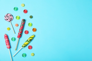 Photo of Flat lay composition with different candies and space for text on color background