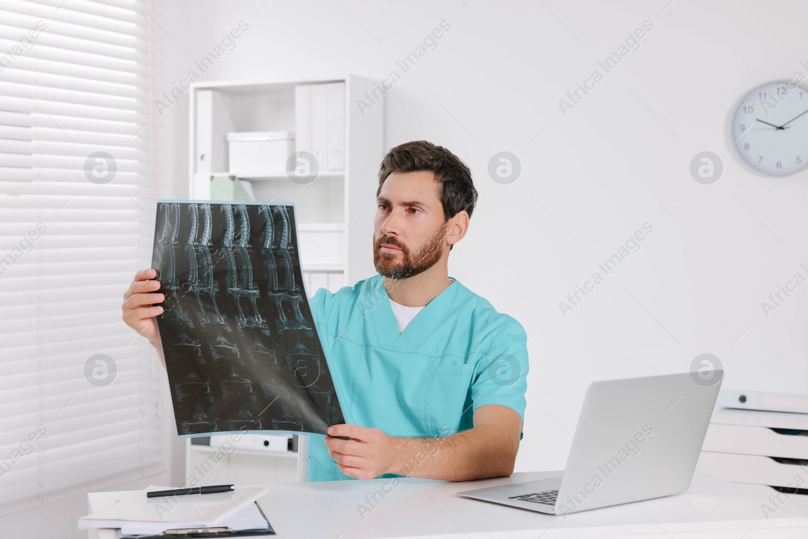 Photo of Doctor examining neck MRI scan in hospital